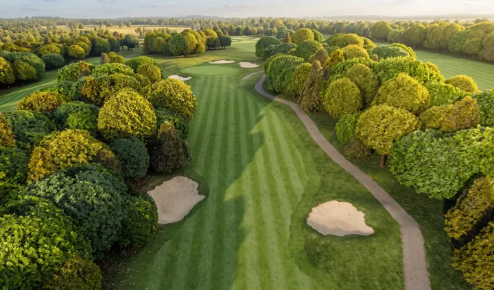 The cart path riding the seventh fairway at River Ridge, a bunker mid-frame.
